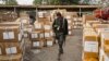 FILE - A police officer keeps guard over electoral materials still stacked in boxes at the offices of the Independent National Electoral Commission in Kano, in northern Nigeria, Feb. 16, 2019. 