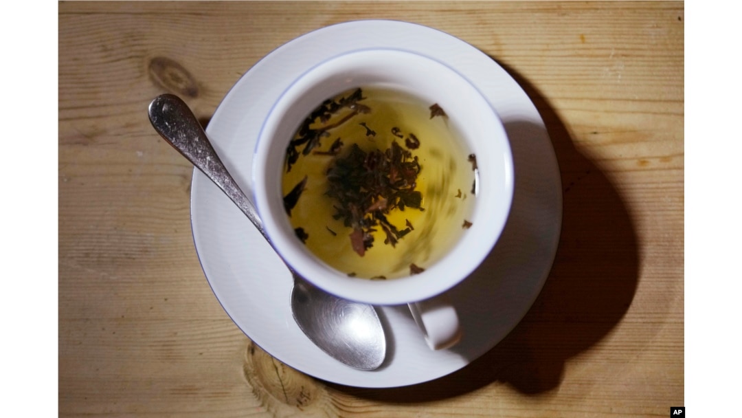 This photo shows a cup of black tea with a spoon and tea leaves in London, Monday, Aug. 29, 2022. (AP Photo/Alastair Grant)