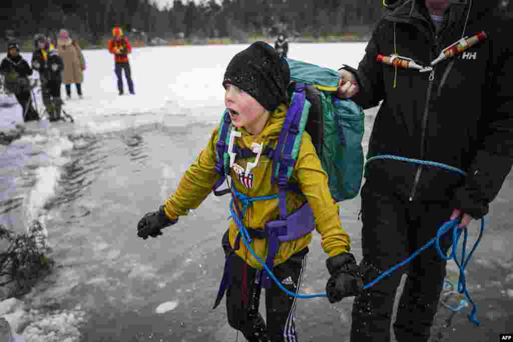 A 5th grade student from Vaxmora School in Sollentuna, north of Stockholm, Sweden, participates in an exercise teaching them what to do when falling through the ice.