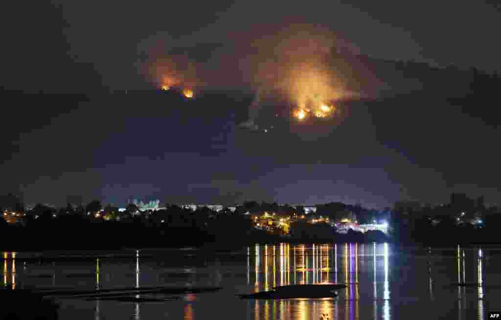 A forest fire approaches the town of Chiguayante, in the province of Concepcion, Chile. More than 5,600 local firefighters, with backup from Mexico, Colombia and Spain, were actively battling 89 priority fires out of a total of 311 burning a week into the disaster, officials said.
