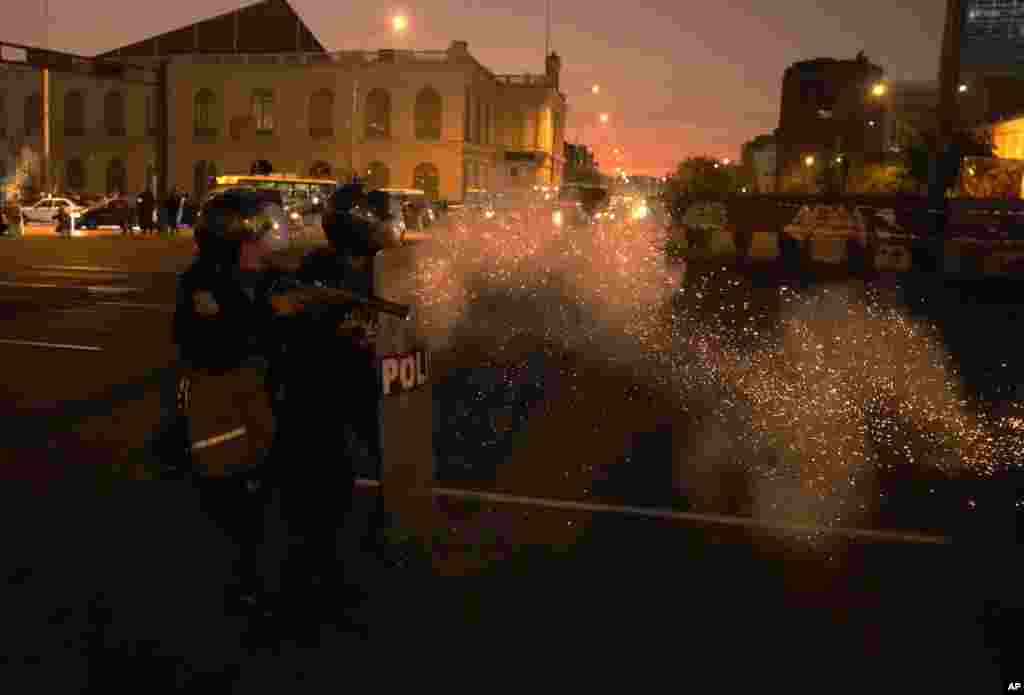 Police in riot gear clash with anti-government protesters during a march against President Dina Boluarte, in Lima, Peru, Jan. 23, 2023.