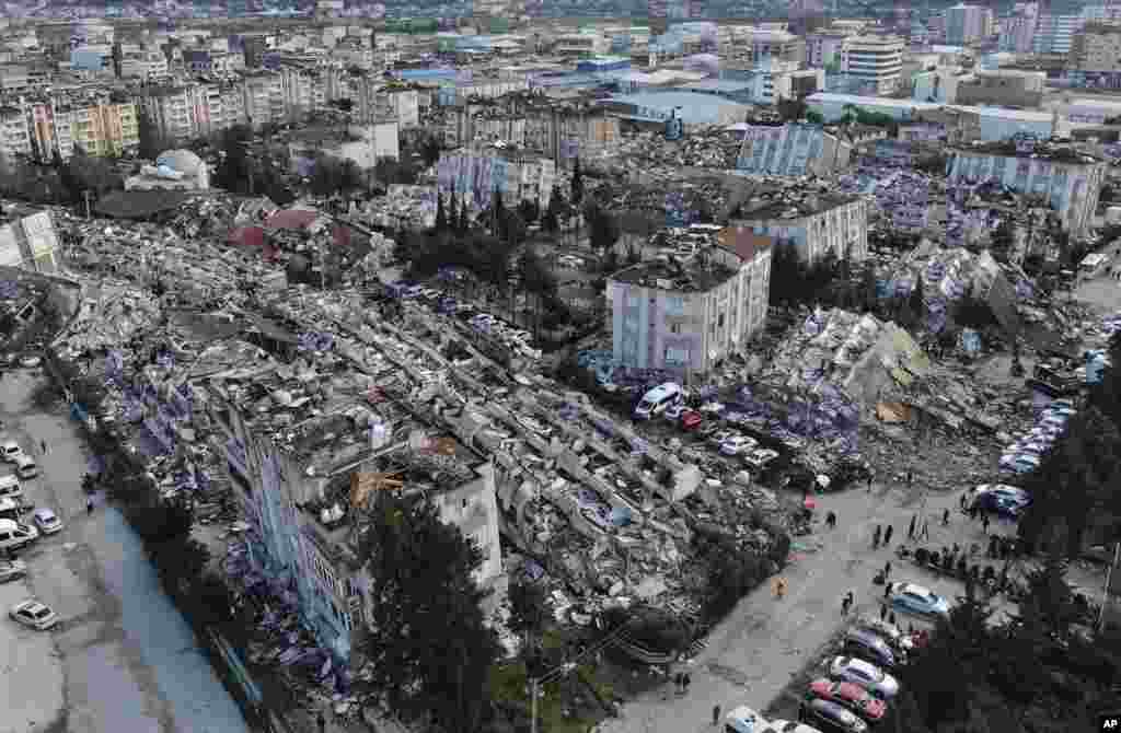 Aerial photo shows the destruction in Hatay city center, southern Turkey. Search teams and emergency aid from around the world poured into Turkey and Syria as rescuers working in freezing temperatures dug — sometimes with their bare hands — through the remains of buildings flattened by a magnitude 7.8 earthquake. 