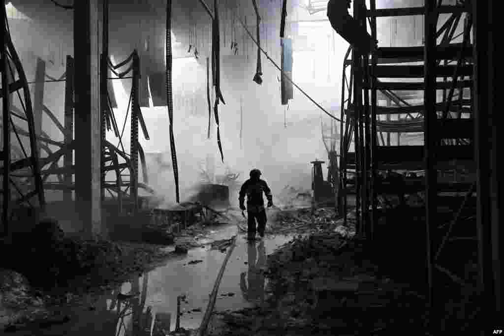 A Ukrainian firefighter walks amid rubble in a shopping mall following a Russian shelling in Kherson, amid the Russian invasion of Ukraine.