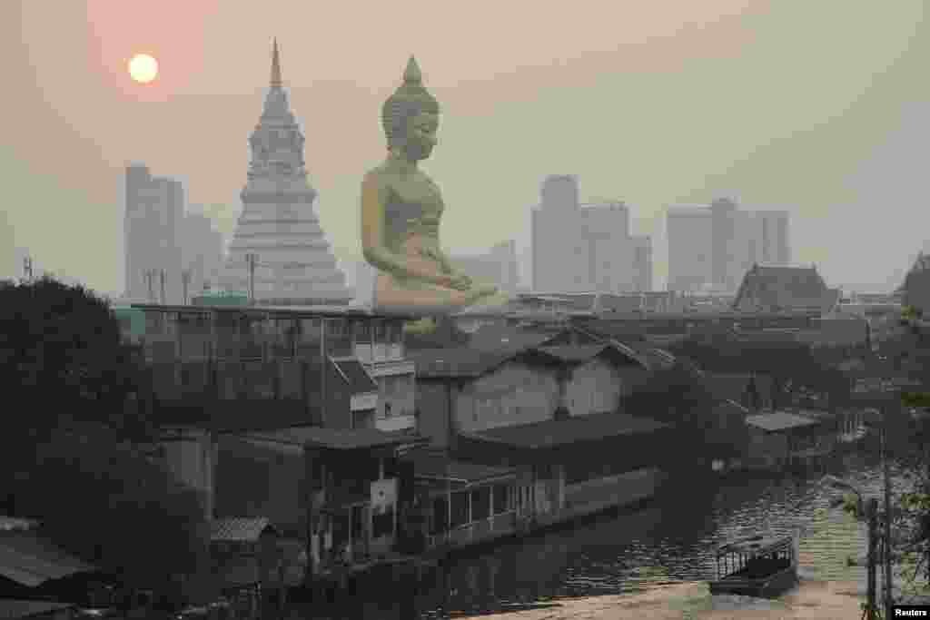 The giant Buddha statue of Wat Paknam Phasi Charoen temple is seen amid air pollution in Bangkok, Thailand.
