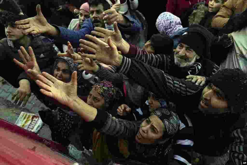 Volunteers distribute aid to people in Antakya, southern Turkey. Thinly stretched rescue teams worked through the night into Wednesday, pulling more bodies from the rubble of thousands of buildings downed in Turkey and Syria by a catastrophic earthquake. 