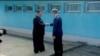 FILE - North Korean leader Kim Jong Un (left) shakes hands with South Korean President Moon Jae-in at the concrete border as both of them arrive for an inter-Korean summit at the truce village of Panmunjom, in this still frame taken from video, South Korea April 27, 2018.