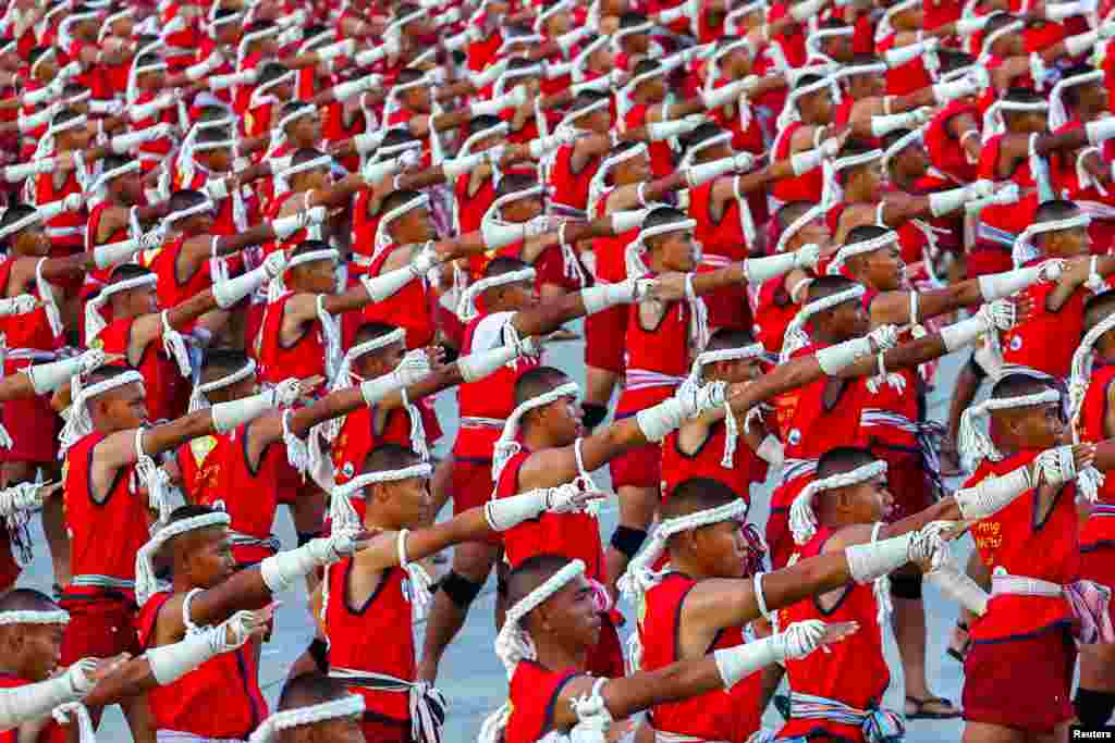 Muay Thai boxers perform the "Wai Khru" to set a Guinness World Record at Rajabhakti Park in Hua Hin, Prachuap Khiri Khan province, Thailand.