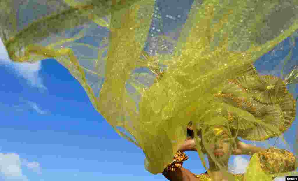 A reveler wears a local Carnival costume during the parade of "Carnaval de Sainte-Rose" in Sainte-Rose, Guadeloupe, Jan. 22, 2023.