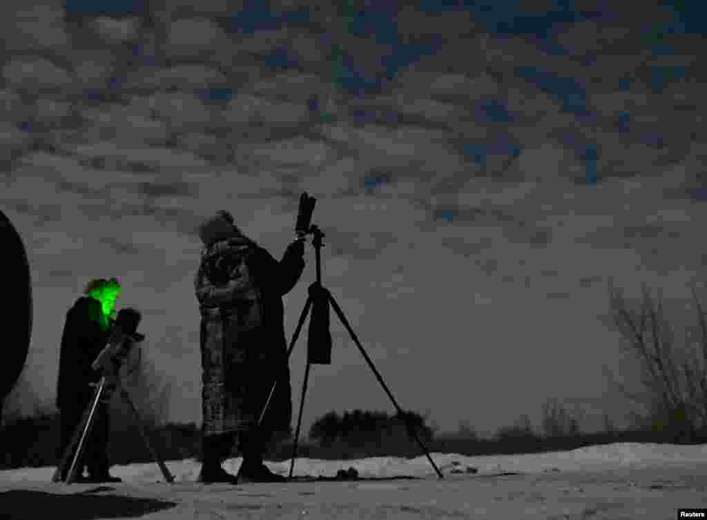 Amateur astronomers watch a green comet named Comet C/2022 E3 (ZTF) outside Omsk, Russia, Feb. 1, 2023.