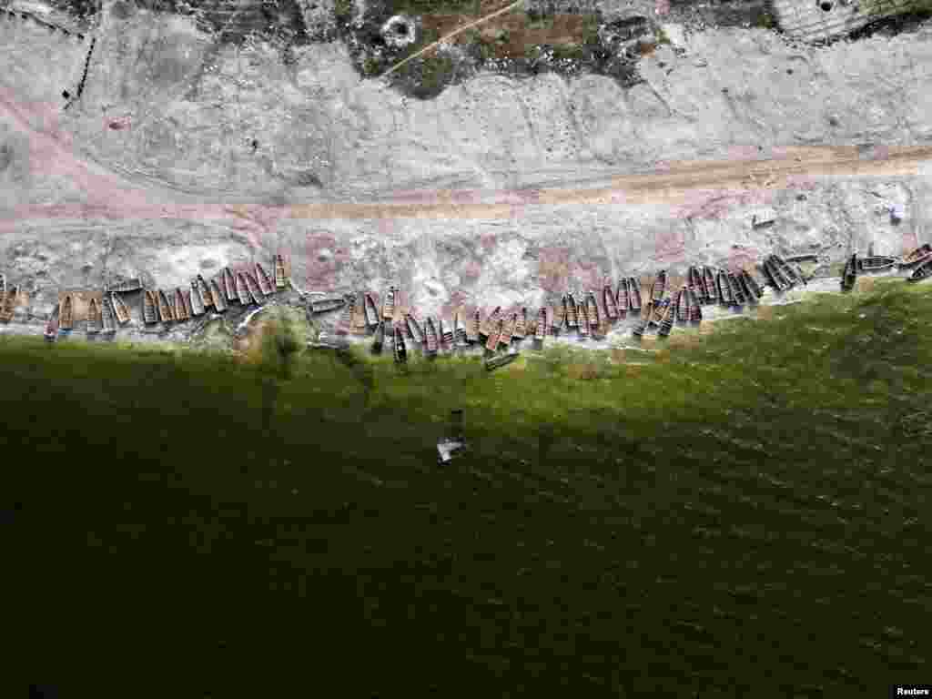 Pirogues lie on the bank of the Pink Lake (Lac Rose), officially known as Lake Retba after extreme floods washed away salt mounts and contaminated the lake and turned its famous waters from Pink to green, in Niaga, near Dakar, Senegal.