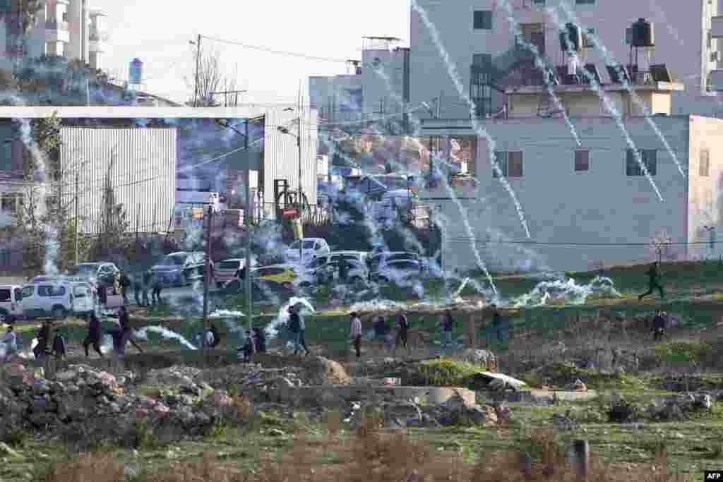 Israeli forces fire tear gas to disperse Palestinian demonstrators during a protest against the expropriation of Palestinian land on the northern entrance to the city of Ramallah, near the Jewish settlement of Beit El, in the occupied West Bank.