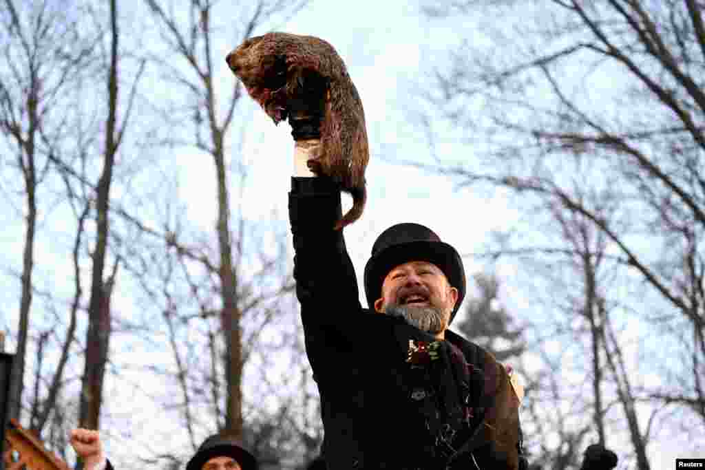 AJ Dereume holds up Phil the groundhog as he is to make his prediction on how long winter will last during the Groundhog Day Festivities, at Gobblers Knob in Punxsutawney, Pennsylvania. Phil saw his shadow, a sign of six more weeks of frosty weather in North America, which so far has enjoyed one of the mildest winters on record.
