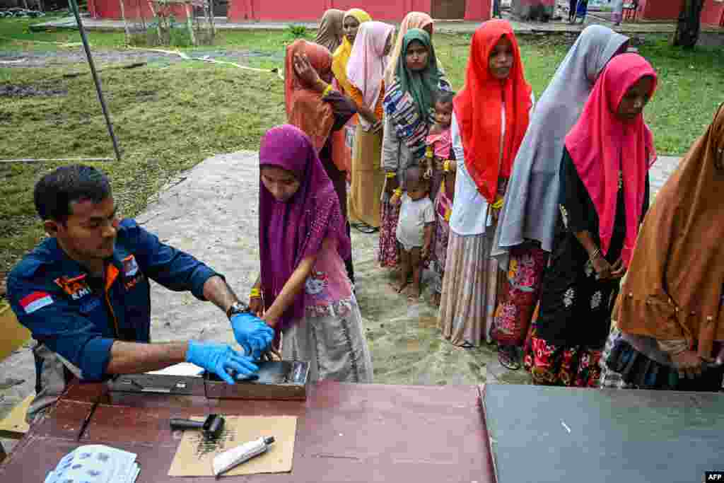 Rohingya refugees register with Indonesian immigration officers at a temporary shelter in Laweueng, Aceh province. Nearly 200 Rohingya refugees arrived by boat in Indonesia on December 27, the fourth such landing in the country in recent months. 