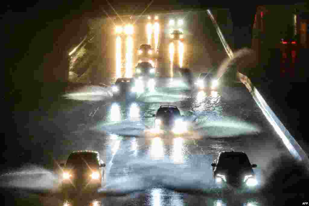 Drivers barrel into standing water on Interstate 101 in San Francisco, California, Jan. 4, 2023. A bomb cyclone smashed into California, bringing powerful winds and torrential rain to areas already saturated by consecutive storms.