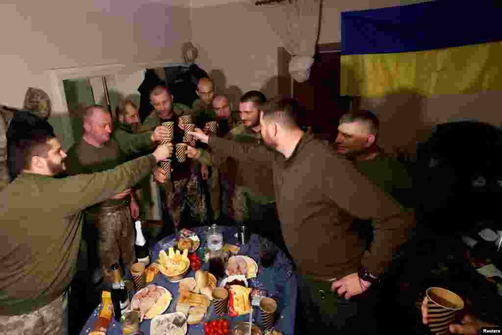Ukrainian soldiers share a toast to celebrate New Years Eve, in a military rest house n region of Donetsk as Russia's attack on Ukraine continues, Dec. 31, 2022.