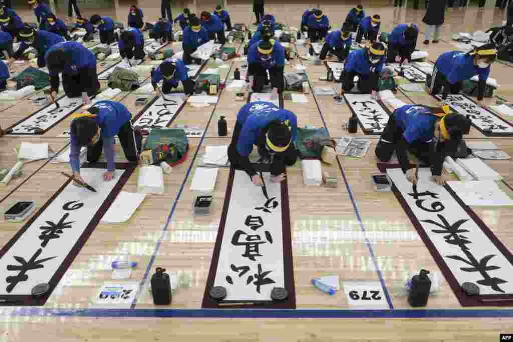 Participants take part in the annual New Year calligraphy contest at Nippon Budokan hall in Tokyo, Japan.