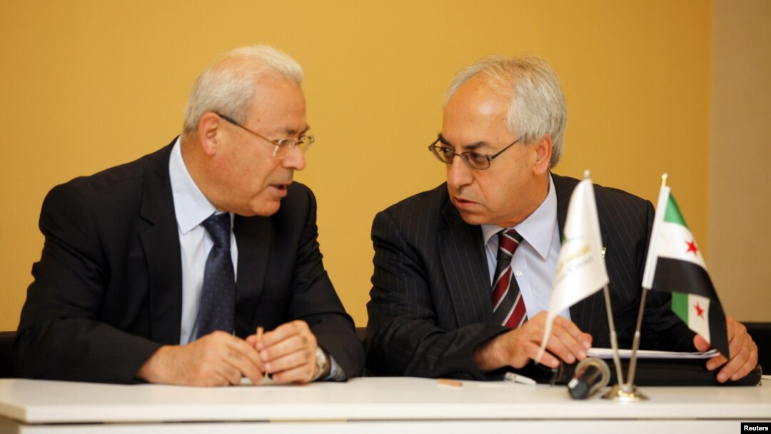 The new president of the Syrian National Council Abdelbaset Seida (R) talks with former President Burhan Ghalioun before a news conference in Istanbul, June 10, 2012.