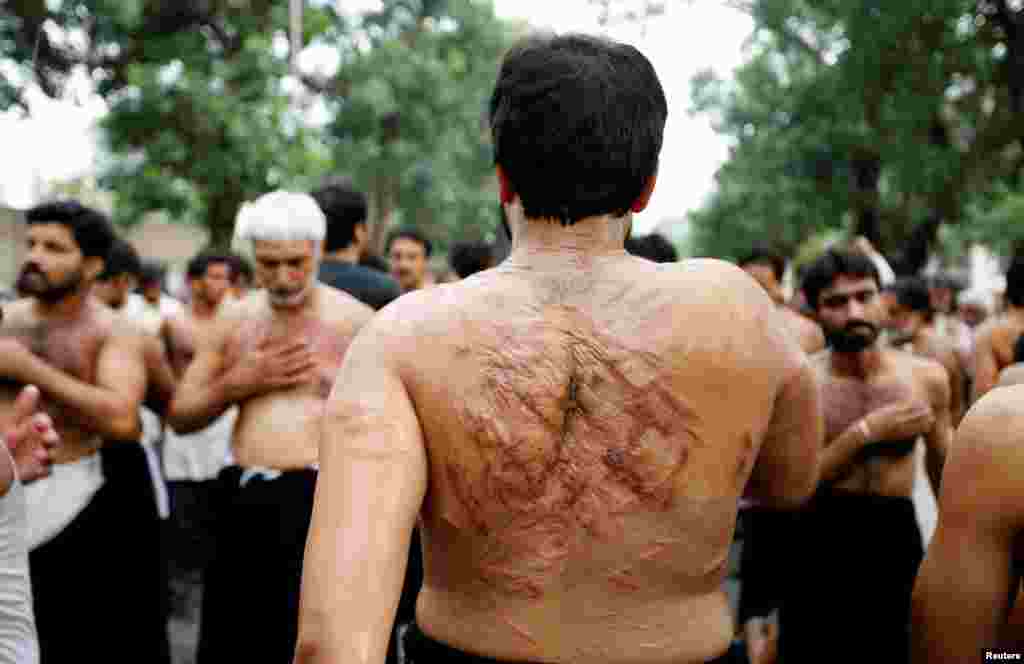 Men flagellate during the Shi'ite Youm Ali procession in Islamabad, Pakistan.