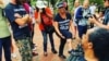 FILE - Shannon Martinez shows the Celtic cross tattoo on her leg to protesters at the “Unite the Right” rally in Washington, D.C., Aug. 12, 2018. (Photo courtesy of Shannon Martinez)