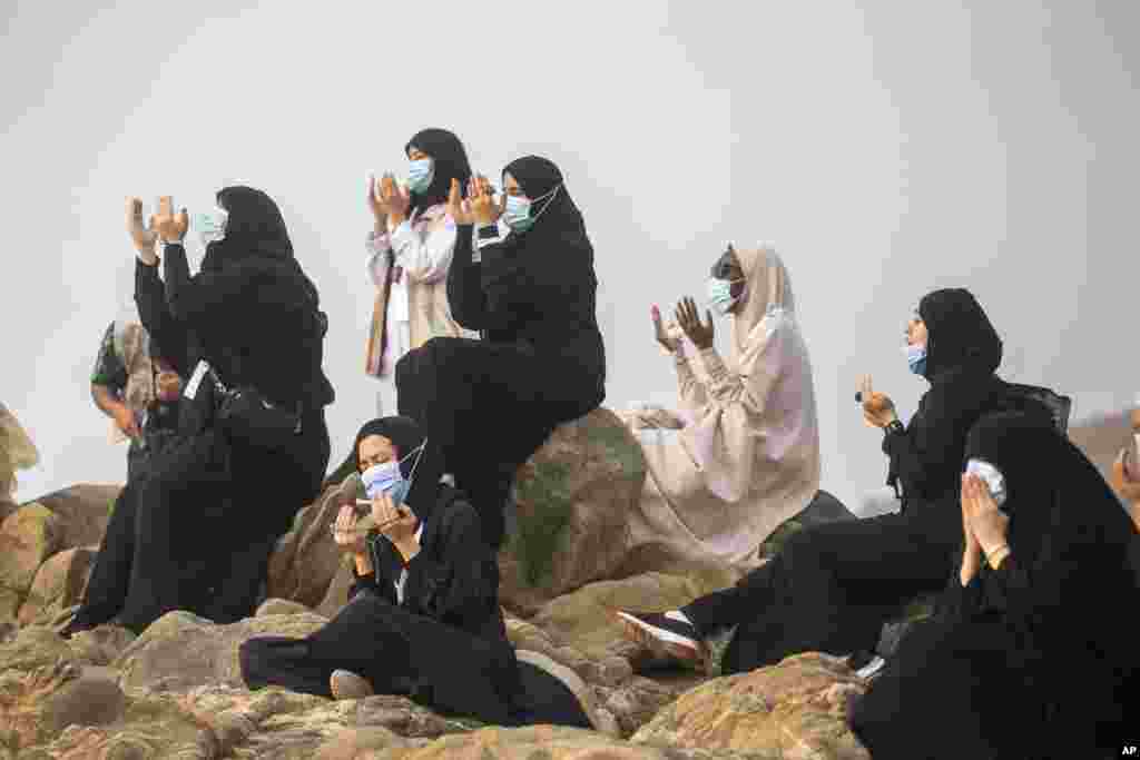 Muslim pilgrims pray on top of the rocky hill known as Mountain of Mercy on the Plain of Arafat during the annual hajj pilgrimage near the holy city of Mecca, Saudi Arabia.