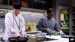 In this Thursday, March 15, 2018, photo, registered dietician Tracey Burg, the head chef of The Teaching Kitchen, left, and Felicha Young prepare a meal during a "Cooking for Recovery" class at the Boston Medical Center in Boston.