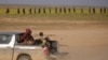 Children from the Yazidi community, who were recently freed after being captured by Islamic State fighters, ride in the back of a truck near Baghuz, Deir el-Zour province, Syria, March 6, 2019.