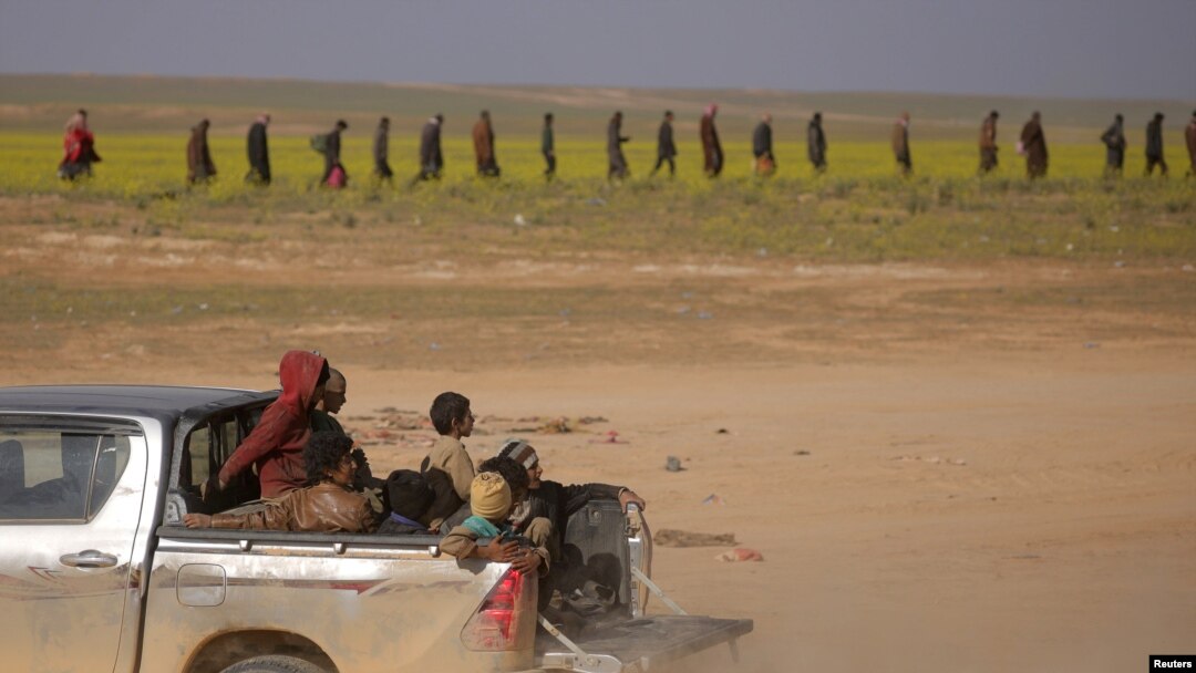 Children from the Yazidi community, who were recently freed after being captured by Islamic State fighters, ride in the back of a truck near Baghuz, Deir el-Zour province, Syria, March 6, 2019.