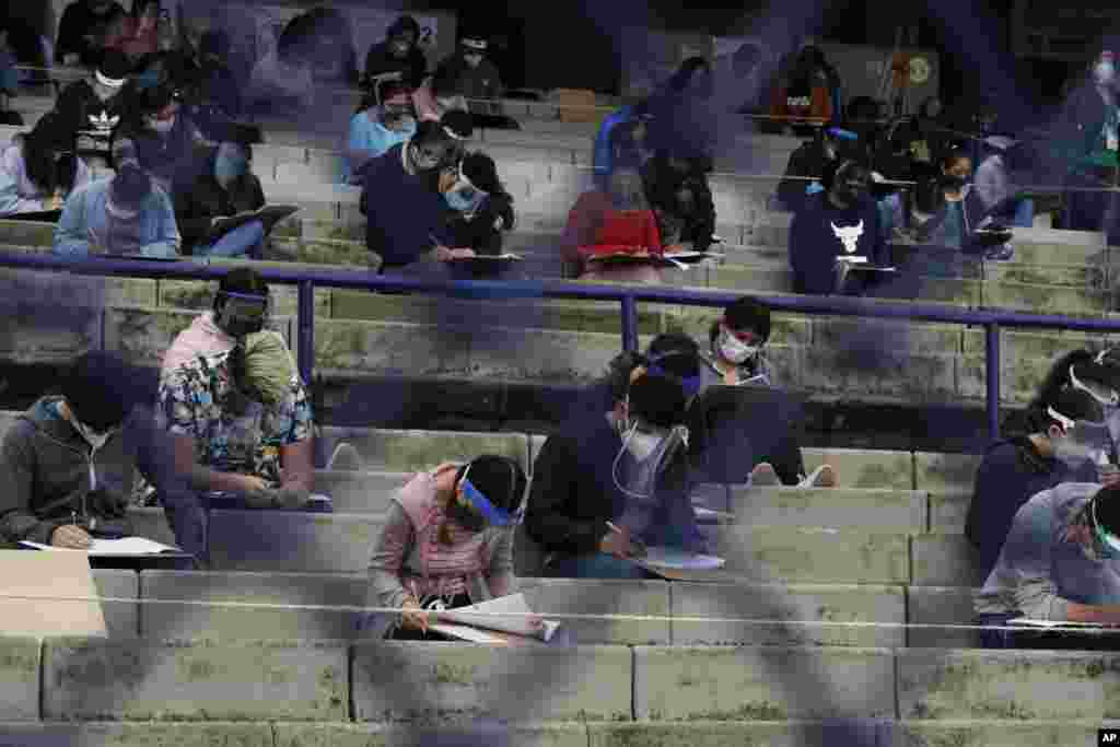Students take an entrance exam for Mexico's National Autonomous University, amid the ongoing coronavirus pandemic at the University Olympic Stadium in Mexico City.