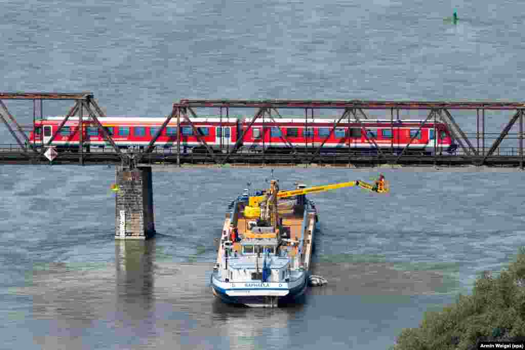 Experts of Deutsche Bahn railways inspect a bridge from a boat on the river Donau near Bogen, Germany.