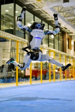A Boston Dynamics Atlas robot performs a jump during a demonstration, Wednesday, Jan. 13, 2021, at the company's facilities in Waltham, Mass. (AP Photo/Josh Reynolds)