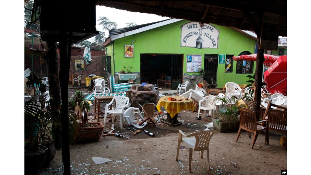 FILE - Damaged chairs and tables lie among the debris strewn after a bomb attack outside an Ethiopian restaurant in Kampala, Uganda, July 12, 2010.