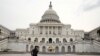 Runners stride past the U.S. Capitol building on the day of U.S. President Donald Trump's evening State of the Union address to a joint session of the U.S. Congress at the Capitol in Washington, U.S. Jan. 30, 2018. 