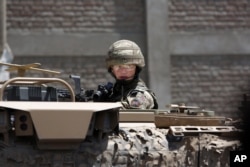 FILE - A U.S. soldier guards a site near Kabul's international airport in Kabul, Afghanistan, May 17, 2015.