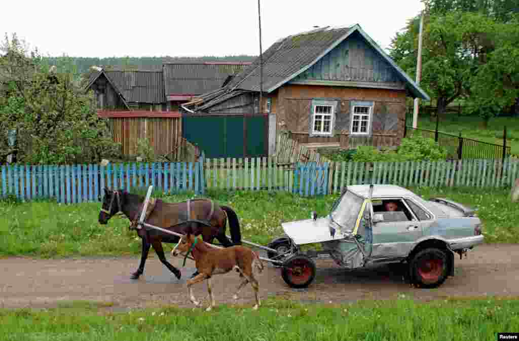 Belarusian shepherd Alexey Usikov drives a horse-drawn carriage, equipped with a battery, head lights, small potbelly stove, which he crafted out of an old Audi-80 calling it jokingly Audi-40 as he used only a half of the car, in the village of Knyazhytsy.