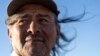 Navajo Richard Begay poses for a portrait while taking a break from herding his goats, on the Navajo Nation in Dilkon, Ariz., Oct. 17, 2024. 