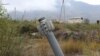 An unexploded projectile of multiple rocket launcher stuck into land near a settlement in self-proclaimed Republic of Nagorno-Karabakh, Azerbaijan, Oct. 1, 2020.
