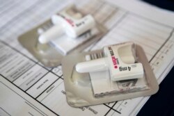 FILE - A Narcan nasal device lies on a counter as a health educator gives instructions on how to administer it, Brooklyn, New York, July 3, 2018.