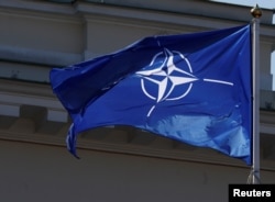 The NATO flag flies during the celebration of the 15th anniversary of Lithuania's membership in NATO in Vilnius, Lithuania, March 30, 2019.