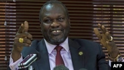 FILE - South Sudan's Riek Machar gestures at a news conference in Kampala, Uganda, Jan. 26, 2016.