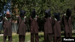 FILE - Insurgents suspected of being from the Haqqani network are presented to the media at the National Directorate of Security (NDS) headquarters in Kabul.