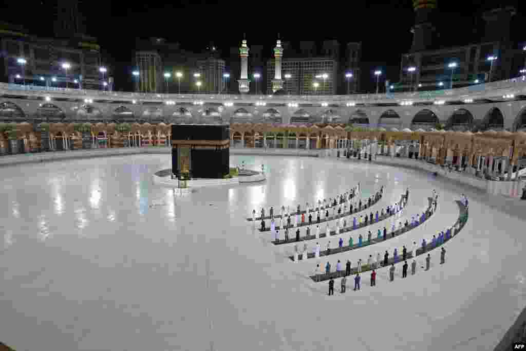 A few worshipers perform al-Fajr prayer at the Kaaba, Islam's holiest shrine, at the Grand Mosque complex in Saudi Arabia's holy city of Mecca.