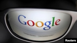 FILE - A Google search page is reflected in sunglasses in this photo illustration taken in Brussels, May 30, 2014.