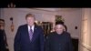 In this image made from video released on March 6, 2019, by North Korean broadcaster KRT, North Korean leader Kim Jong Un, right, smiles while walking with U.S. President Donald Trump for a meeting in Hanoi, Vietnam. 
