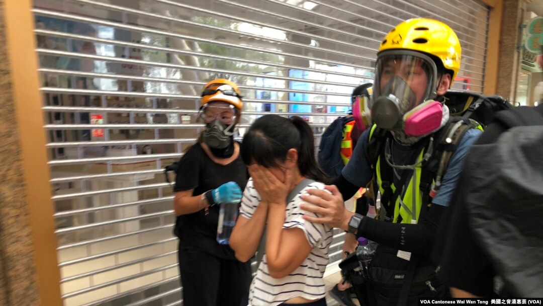 有市民不知道警方在德福花園商場施放催淚彈驅散示威者，被催淚煙波及，雙眼刺痛，由示威者護送到安全地點 (攝影：美國之音湯惠芸)