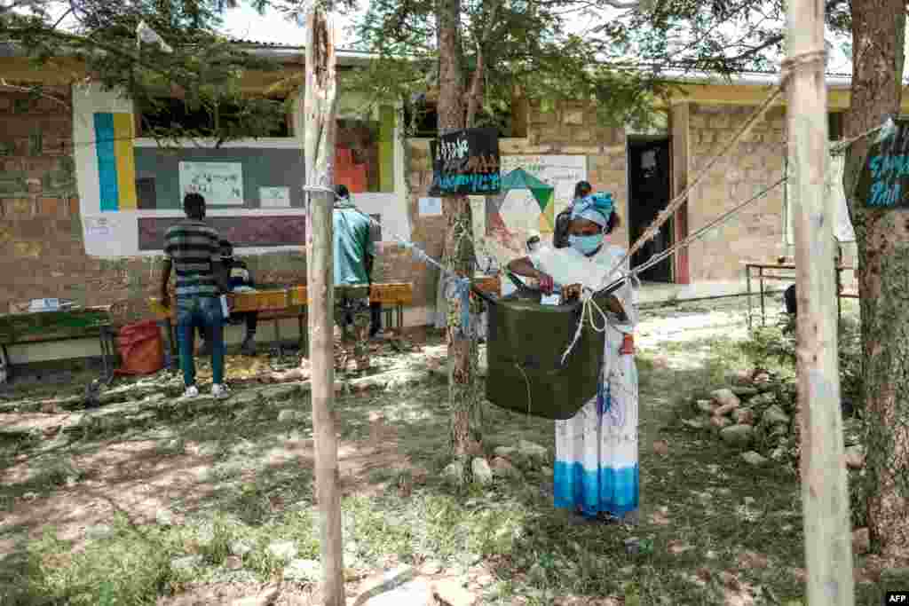 A woman casts her ballot at a polling station during Tigray’s regional elections, in the town of Tikul, 15 kms east from Mekele, Ethiopia.
