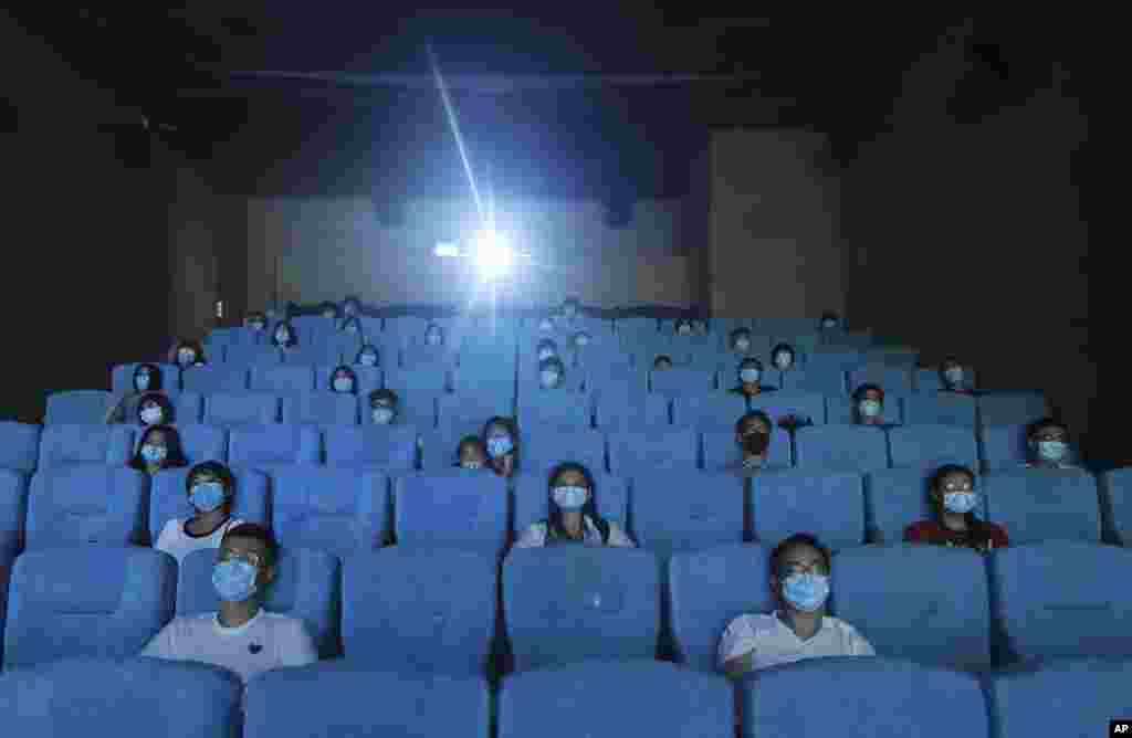 Movie-goers are spaced apart as they watch a movie in a newly reopened cinema in Hangzhou in eastern China's Zhejiang province.