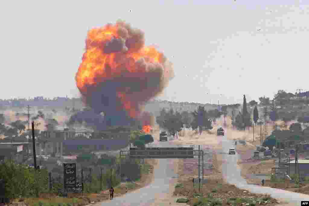 A fireball erupts from the site of an explosion reportedly targeting a joint Turkis-Russian patrol on the strategic M4 highway, near the Syrian town of Ariha in the rebel-held northwestern Idlib province.