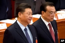 中國國家主席習近平與總理李克強在北京人大會堂出席全國人大會議閉幕式。（2019年3月15日）