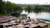 People rest at a one of parks by the Moscow River during a hot day in Moscow, Russia, June 9, 2020. 