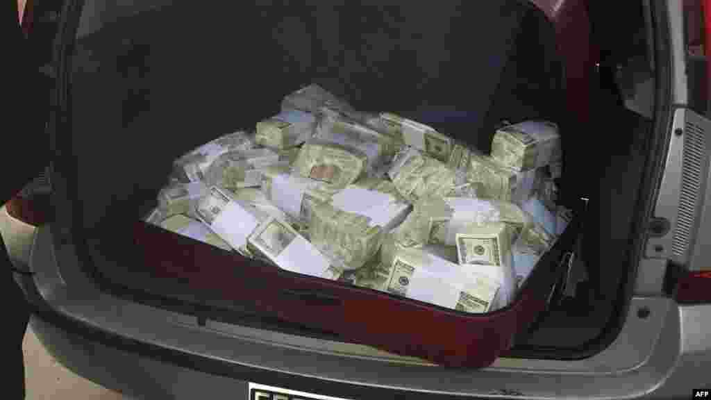 Handout photo released by Telam of dollar wads seized to Argentinian former Secretary of Public Works (2003-2015) Jose Lopez in Buenos Aires on June 14, 2016.